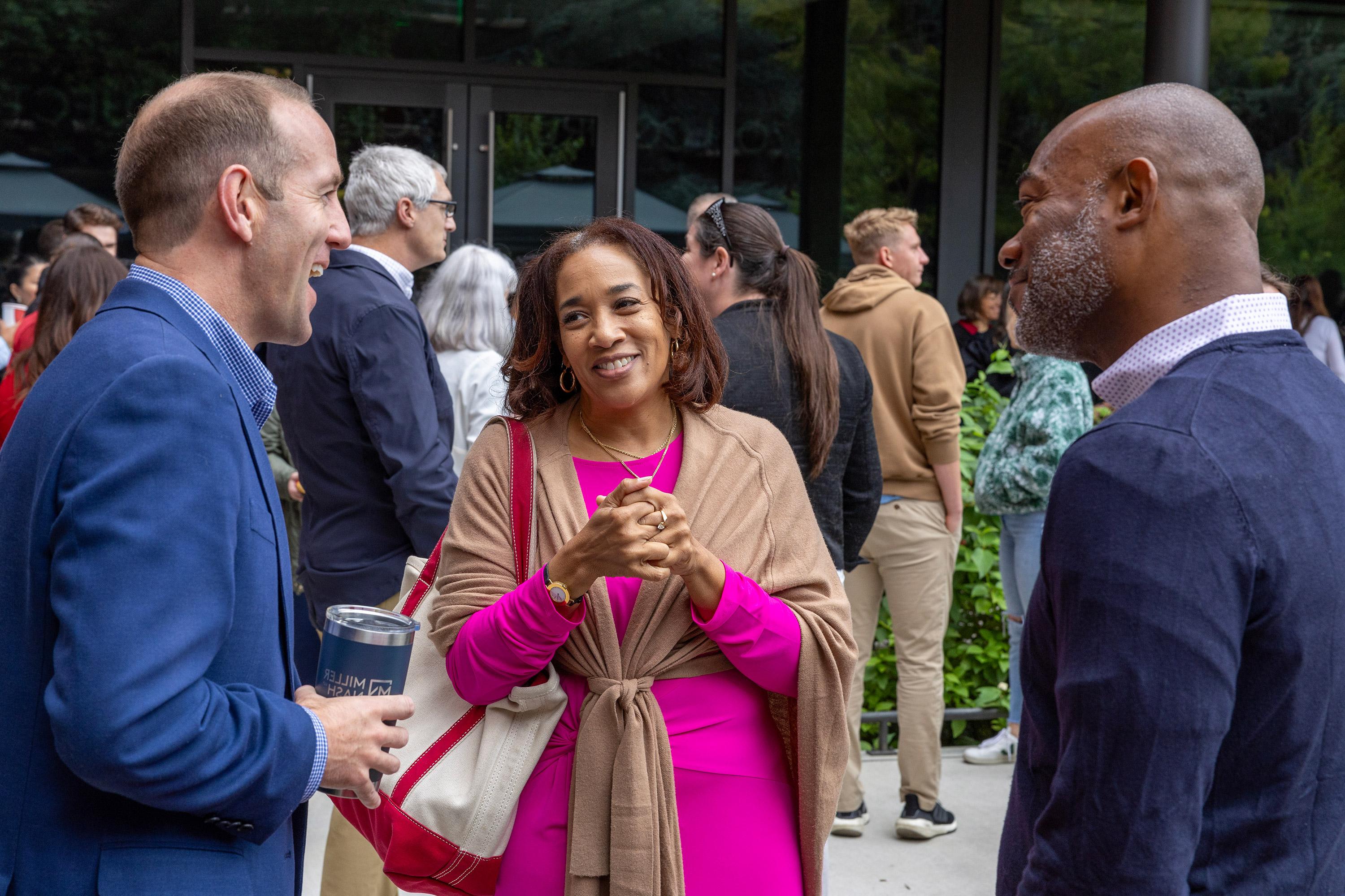 groups of people mingling at an event on campus